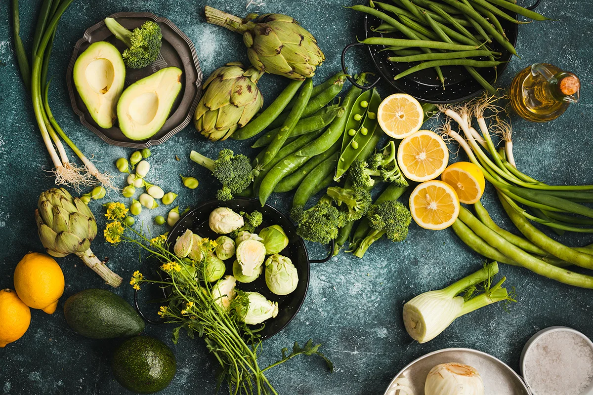 An arrangement of seasonal veggies like avocados and asparagus, showing the concept of what's in season in Napa supermarkets this spring
